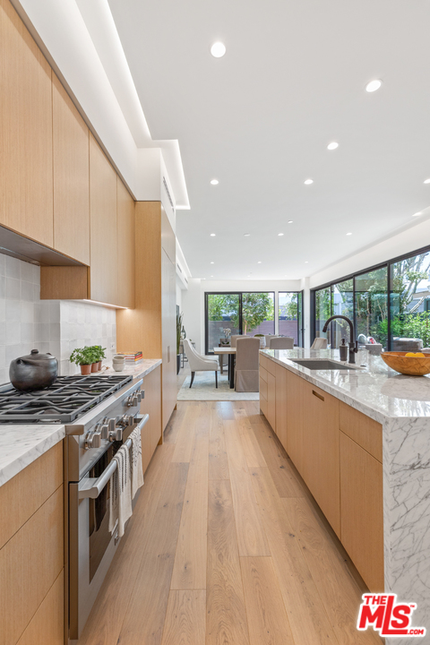 1620 Electric Avenue Venice, CA 90291 - Photo 7 of 31 a kitchen with stainless steel appliances granite countertop a stove a sink and a refrigerator