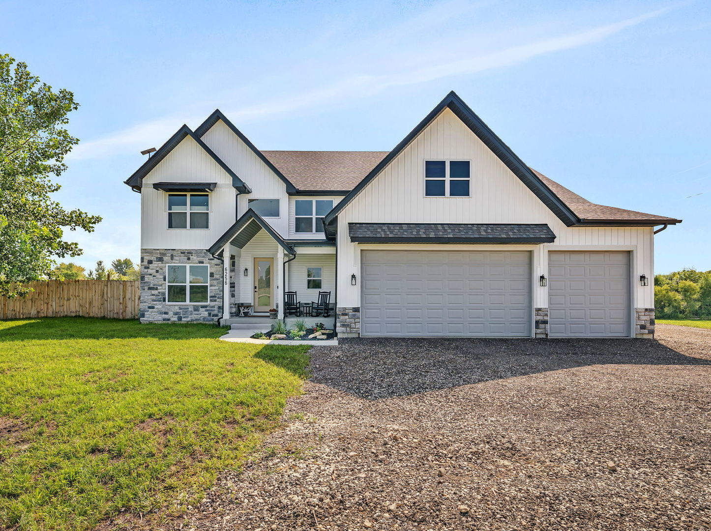 a front view of a house with yard and garage