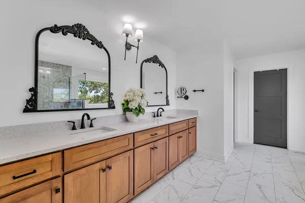 a bathroom with a sink a toilet and a mirror