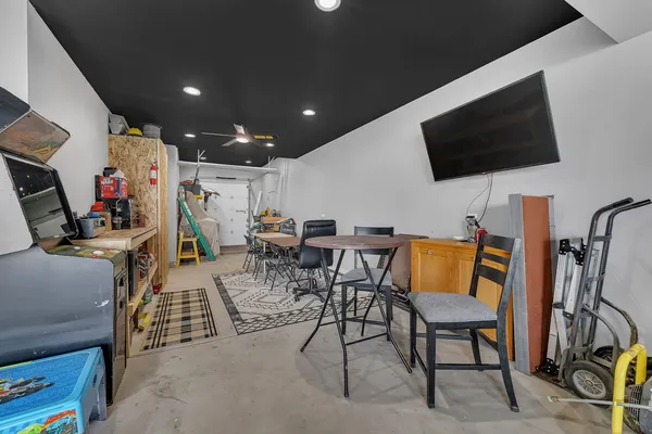 a backyard of a house with barbeque oven table and chairs
