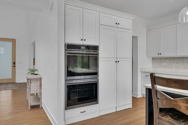a kitchen with a refrigerator a sink and cabinets