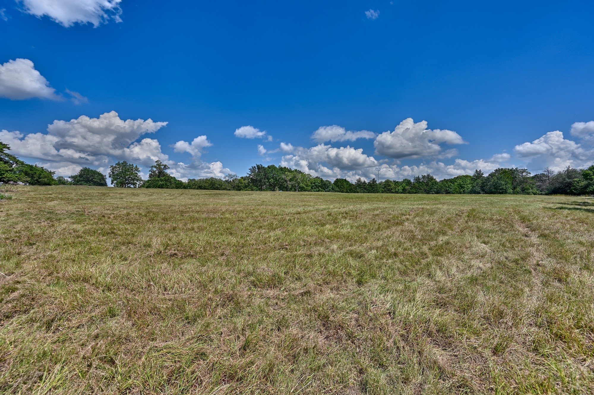 7515 Shelby Road Burton, TX 77835 - Photo 17 of 26 a view of a big yard with an outdoor space and seating area