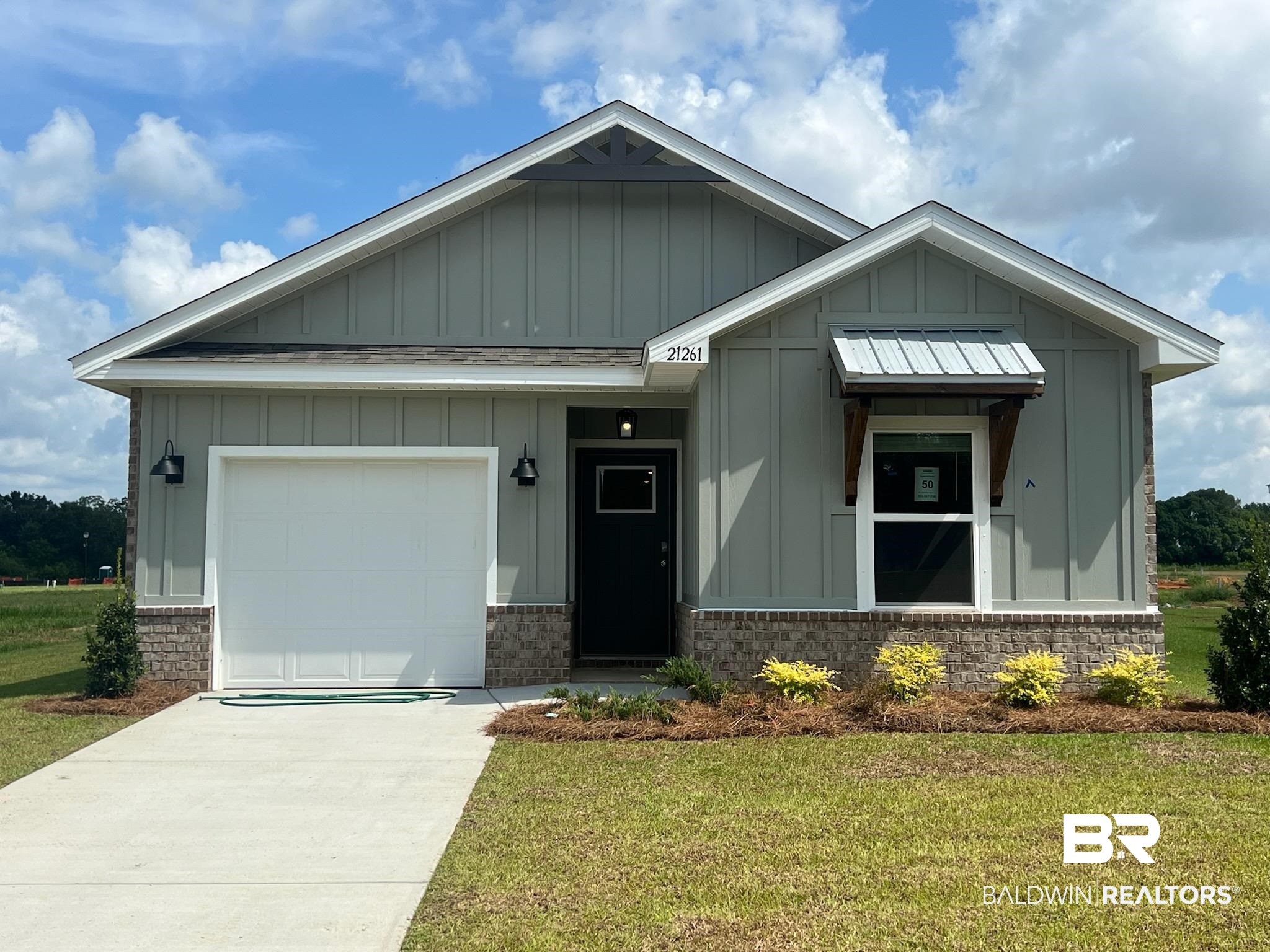 21261 Roughleaf Drive Summerdale, AL 36580 - Photo 1 of 1 Craftsman-style house featuring a garage and a front yard