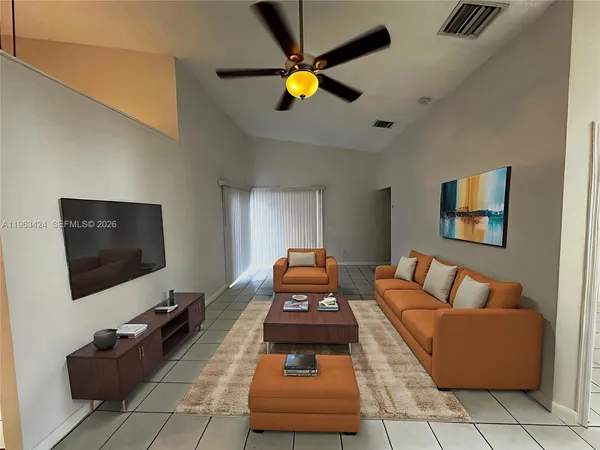 a living room with furniture and a flat screen tv