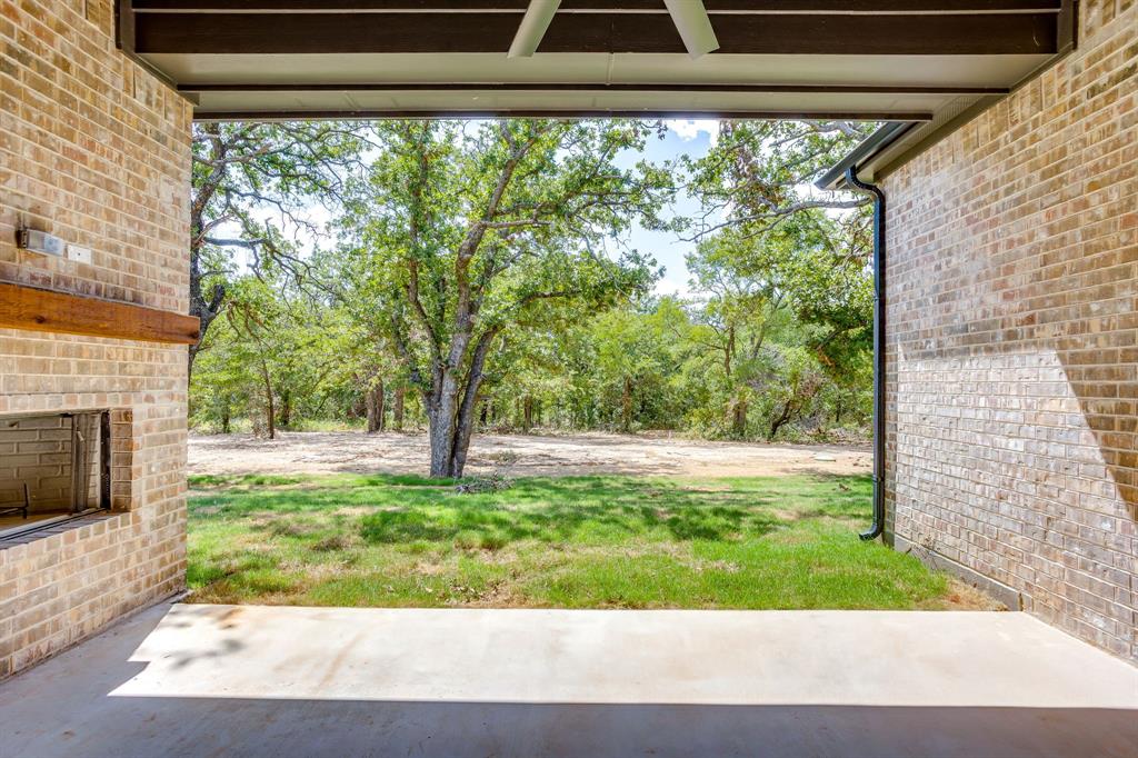 608 Tay Tay Way Springtown, TX 76082 - Photo 33 of 40 Back patio with fireplace