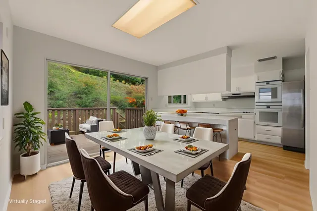 a kitchen with stainless steel appliances a refrigerator a stove and white cabinets