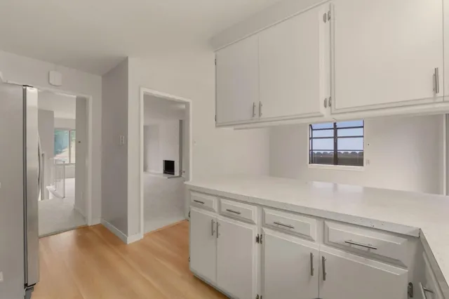 a bedroom with bed and a potted plant