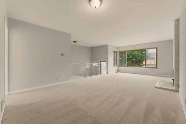 a view of an empty room with a fireplace