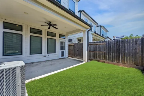 a view of a house with backyard and porch