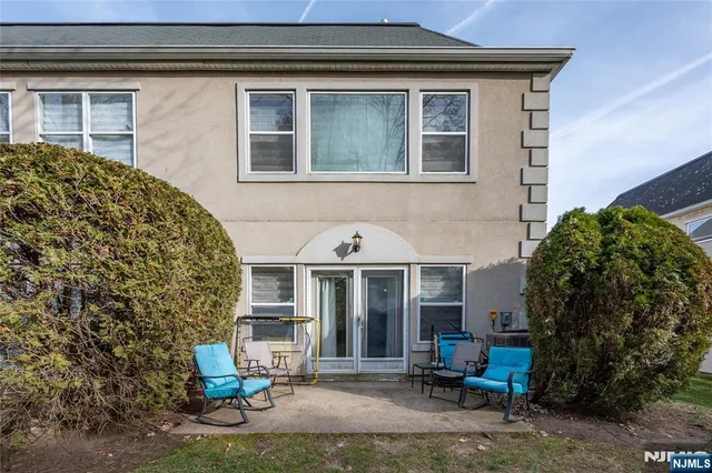a front view of a house with outdoor seating