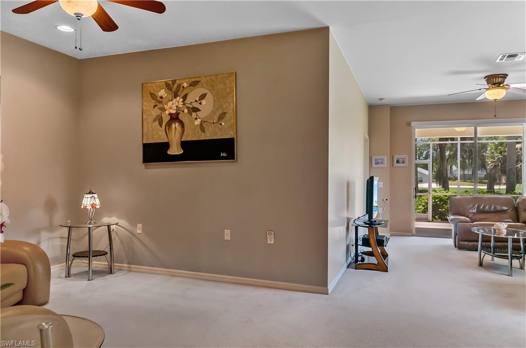 21520 Portrush Run Estero, FL 33928 - Photo 12 of 34 a living room with furniture and a large window