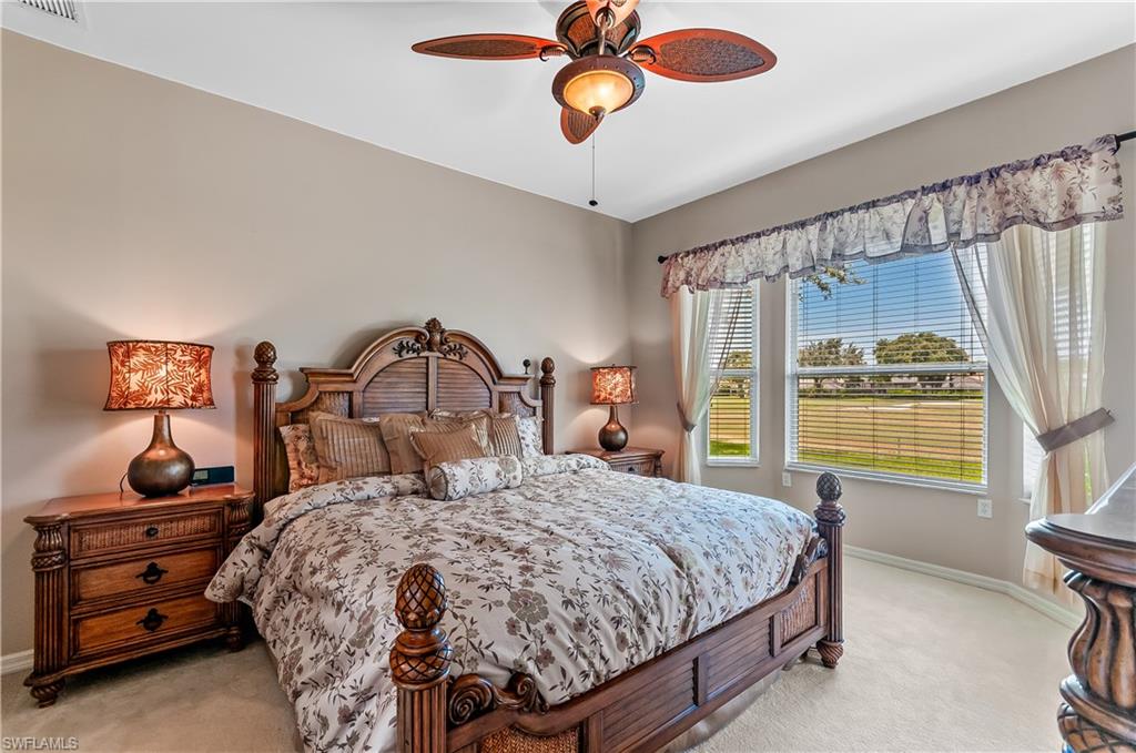 21520 Portrush Run Estero, FL 33928 - Photo 13 of 34 a bedroom with a bed and a window