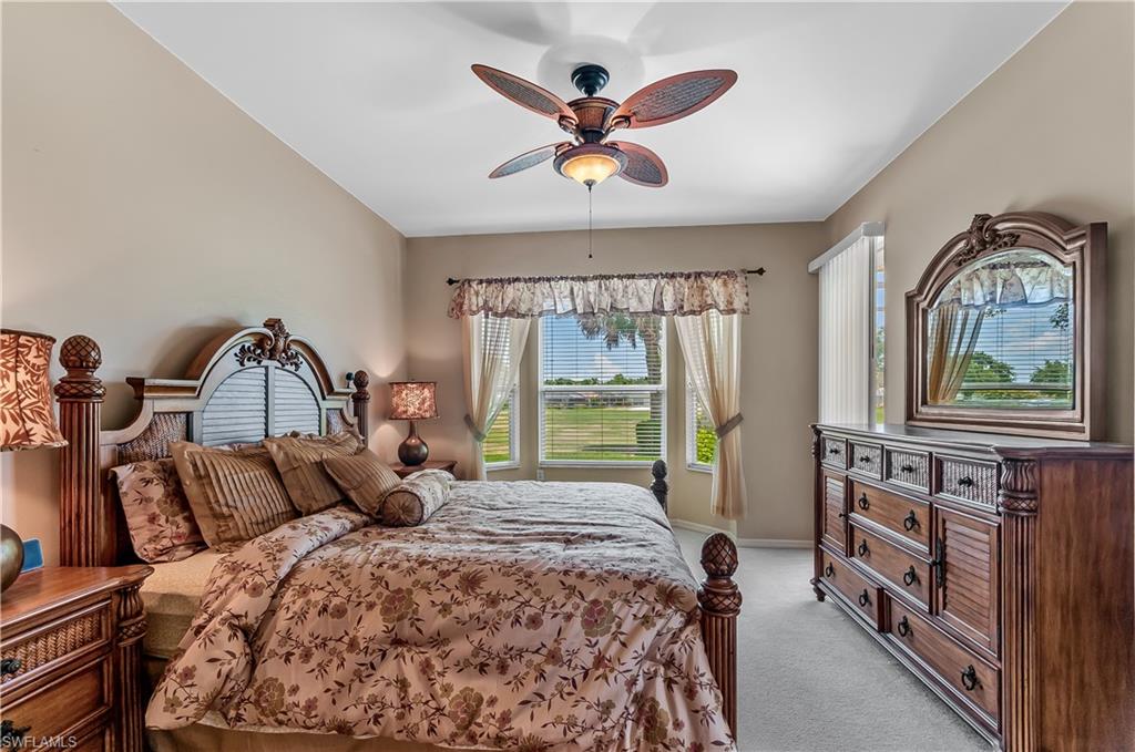 21520 Portrush Run Estero, FL 33928 - Photo 14 of 34 a bedroom with a bed and a large window