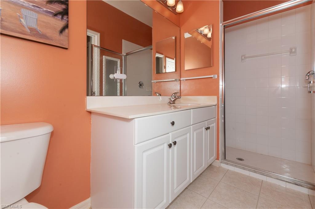 21520 Portrush Run Estero, FL 33928 - Photo 15 of 34 a bathroom with a sink a toilet and mirror