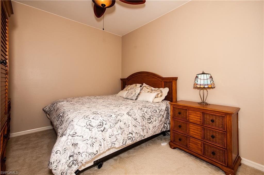 21520 Portrush Run Estero, FL 33928 - Photo 16 of 34 a bedroom with a bed and cabinets