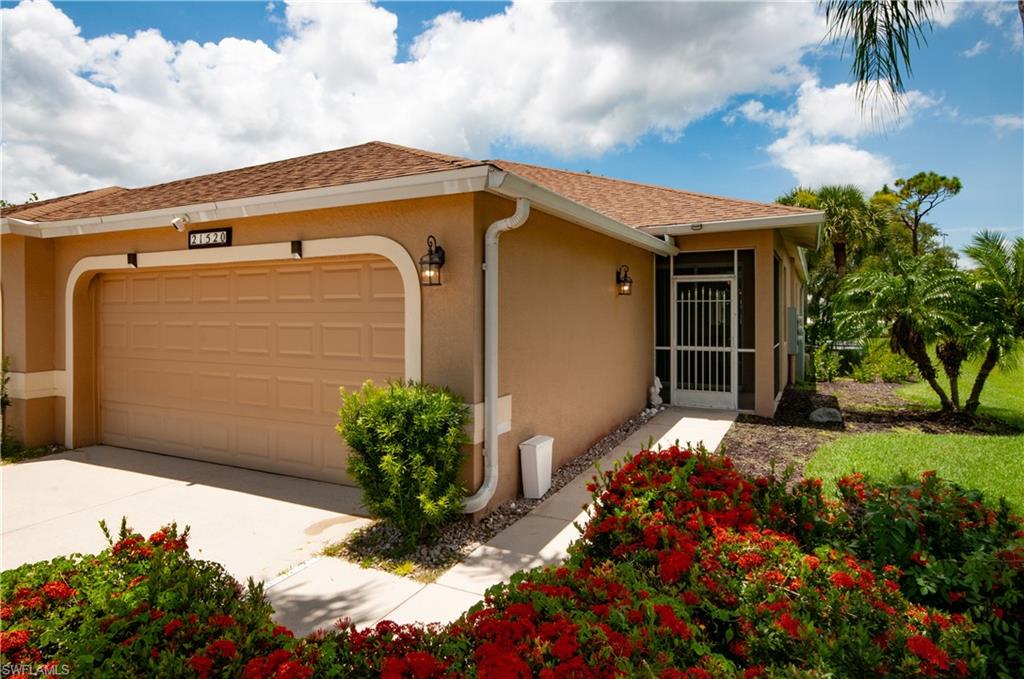21520 Portrush Run Estero, FL 33928 - Photo 2 of 34 a front view of a house with a yard