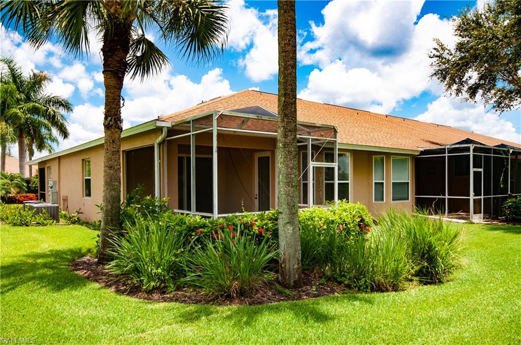21520 Portrush Run Estero, FL 33928 - Photo 21 of 34 a view of a house with a yard and potted plants