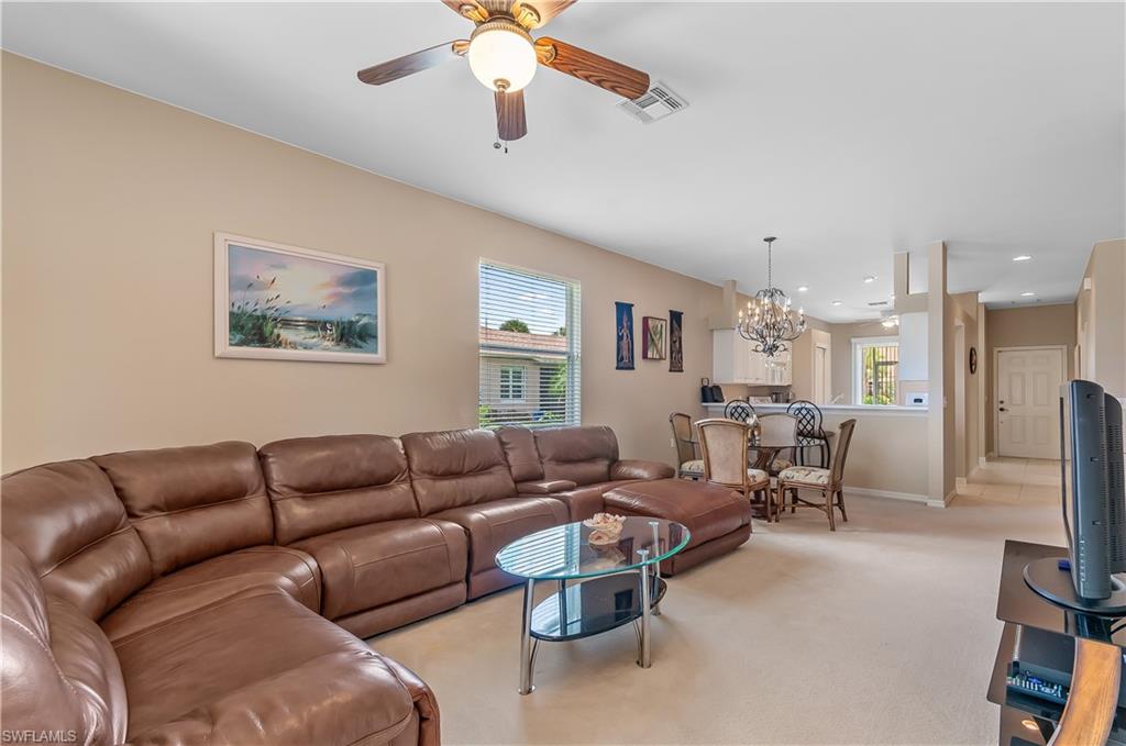 21520 Portrush Run Estero, FL 33928 - Photo 6 of 34 a living room with furniture and a chandelier
