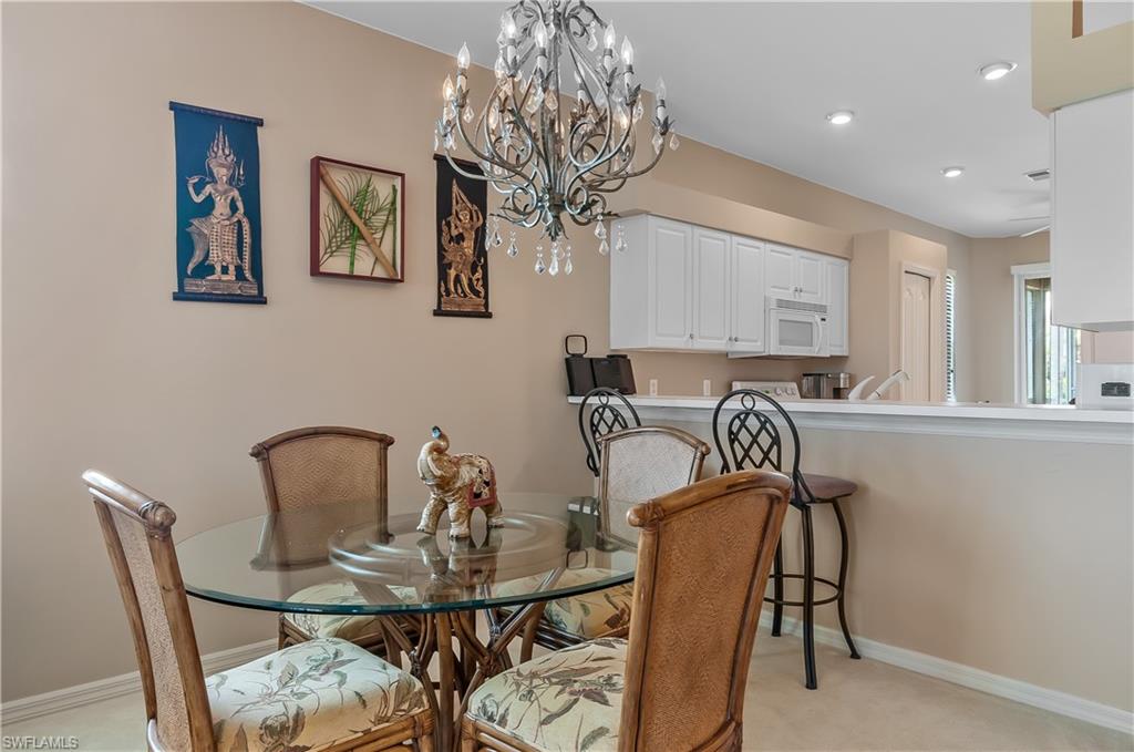 21520 Portrush Run Estero, FL 33928 - Photo 7 of 34 a view of a dining room with furniture and chandelier