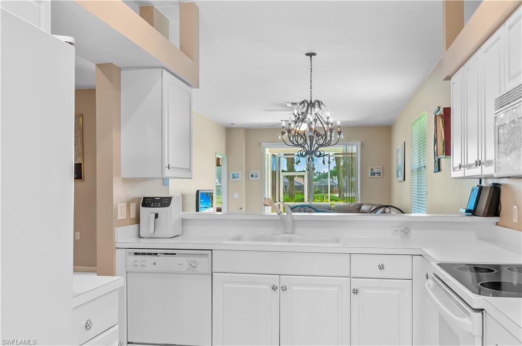 21520 Portrush Run Estero, FL 33928 - Photo 9 of 34 a kitchen with a sink and cabinets