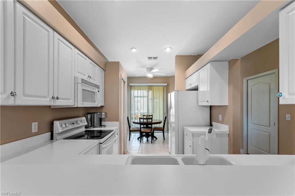 21520 Portrush Run Estero, FL 33928 - Photo 10 of 34 a living room with furniture a wooden floor and a fireplace
