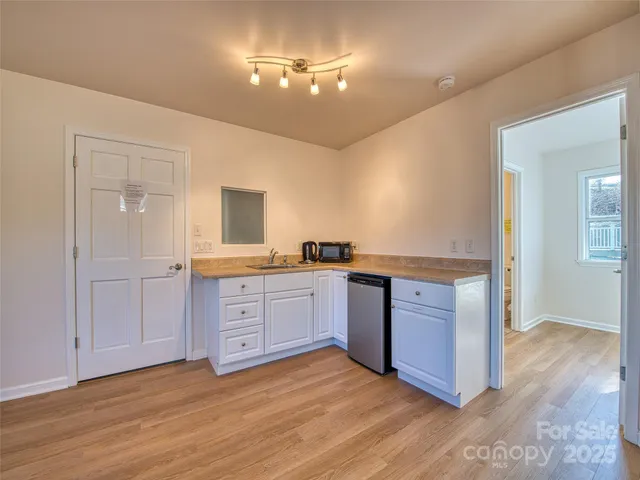 a kitchen with granite countertop a stove and a sink