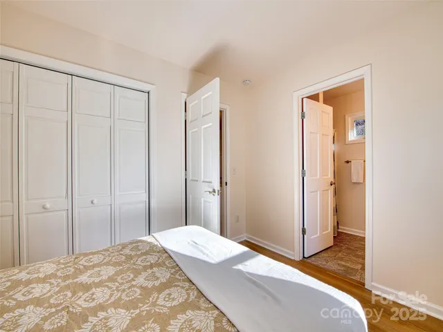 a bedroom with a bed and a mirror