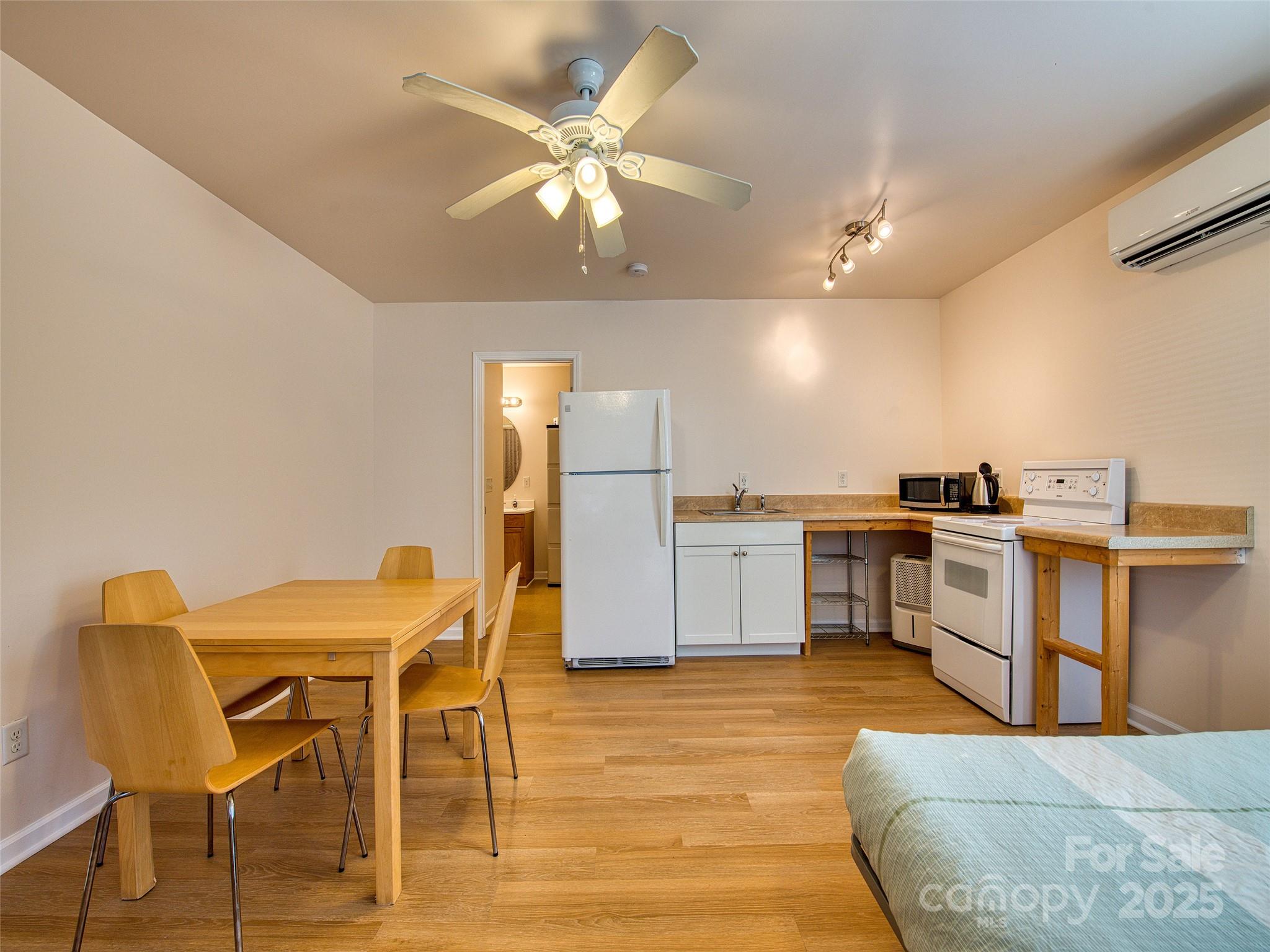 12 Lila Lane Leicester, NC 28748 - Photo 20 of 33 a kitchen with a table chairs refrigerator and microwave