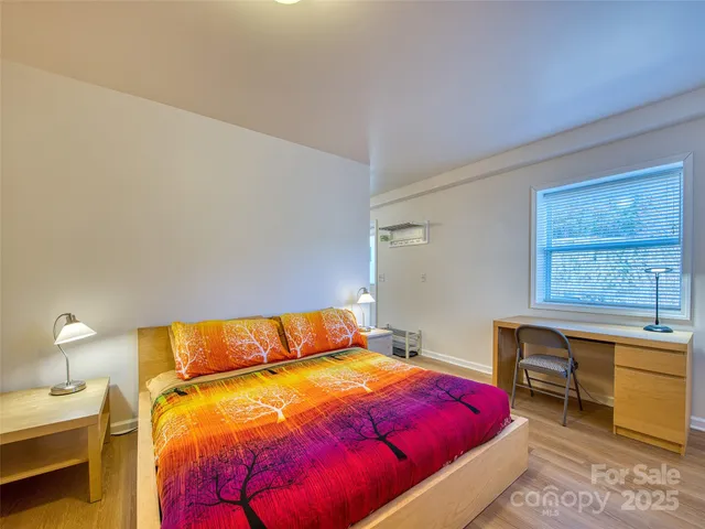 a bedroom with a bed and a table