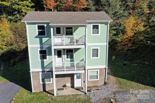 a front view of a house with a yard garage and outdoor seating