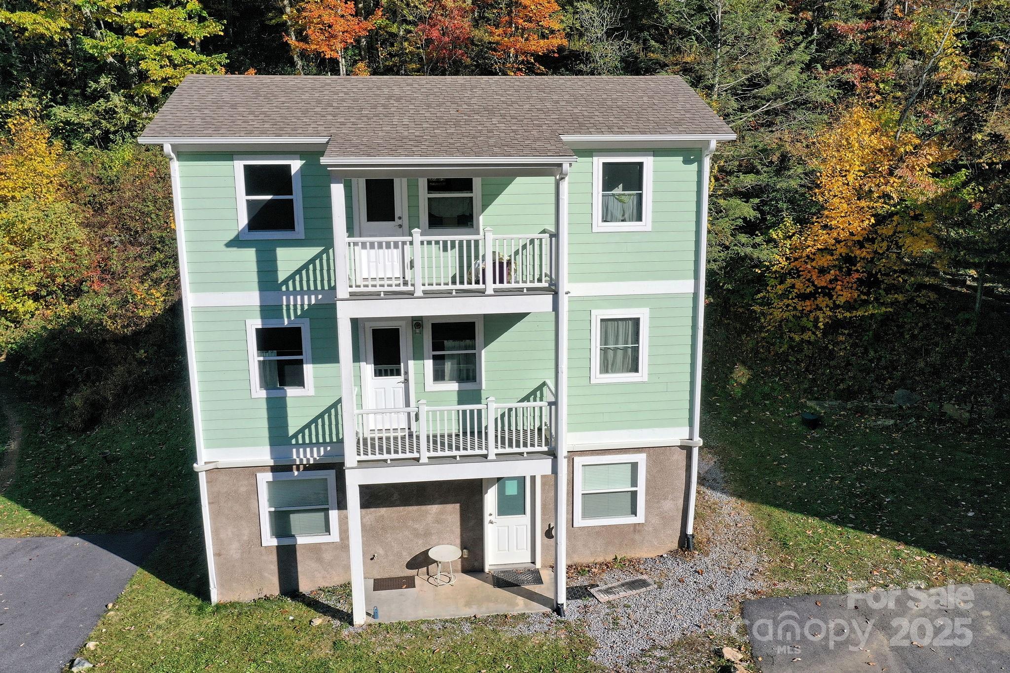 12 Lila Lane Leicester, NC 28748 - Photo 25 of 33 a front view of a house with a yard garage and outdoor seating