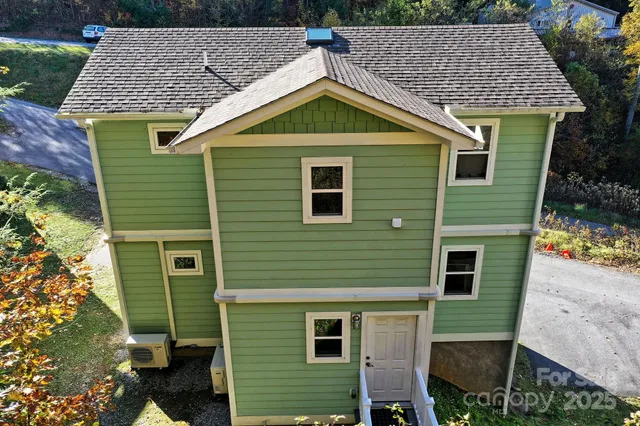 an aerial view of a house with a yard