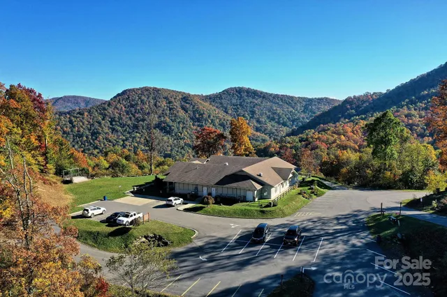 an aerial view of house with mountain in the background
