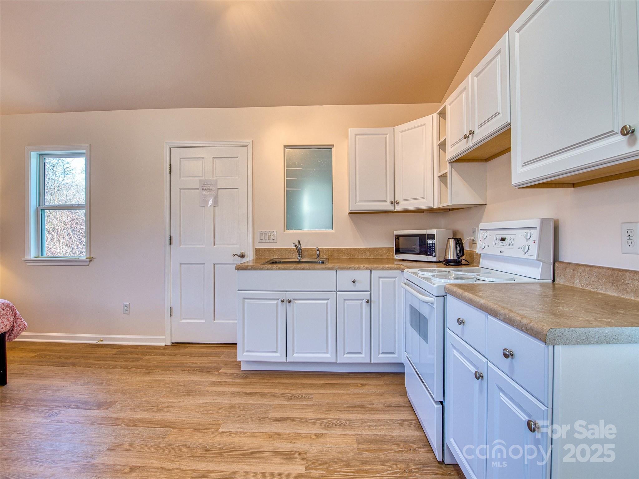 12 Lila Lane Leicester, NC 28748 - Photo 6 of 33 a kitchen with granite countertop a sink and cabinets