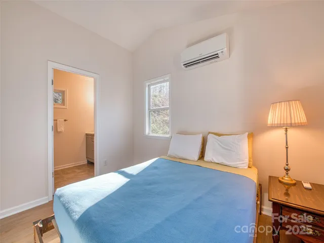 a bedroom with a bed and a lamp