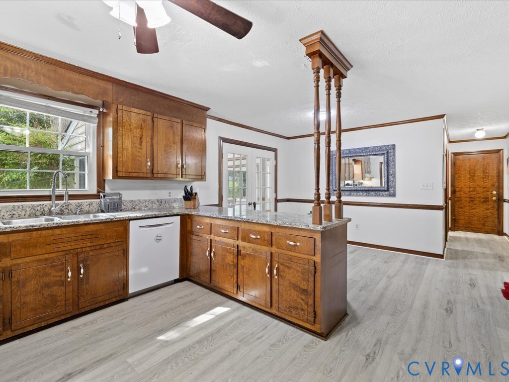 4411 Overridge Drive Chester, VA 23831 - Photo 14 of 35 a kitchen with stainless steel appliances granite countertop wooden cabinets a stove a sink and a large window