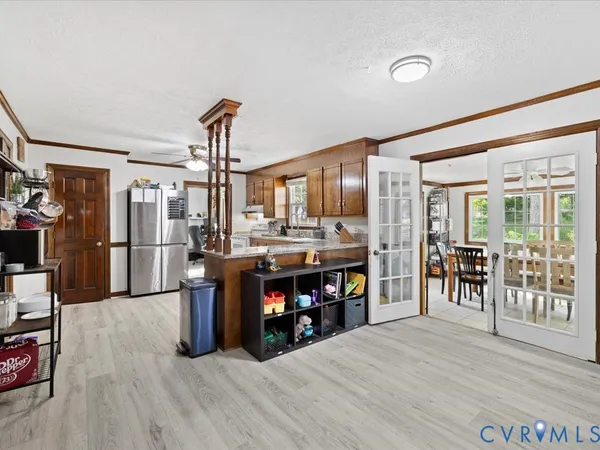 a view of a dining room with furniture a chandelier and wooden floor