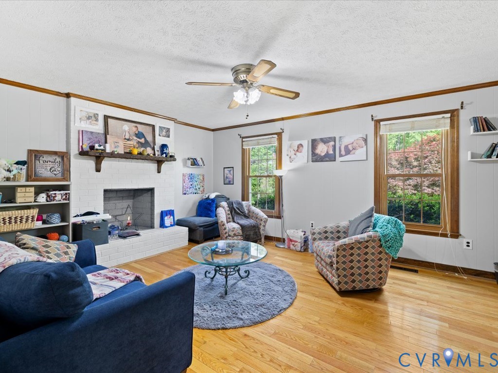 4411 Overridge Drive Chester, VA 23831 - Photo 17 of 35 a living room with furniture a fireplace and a large window