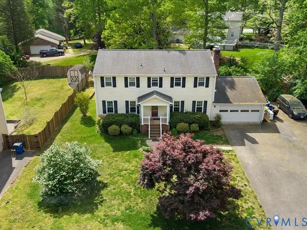 an aerial view of a house with yard swimming pool and outdoor seating