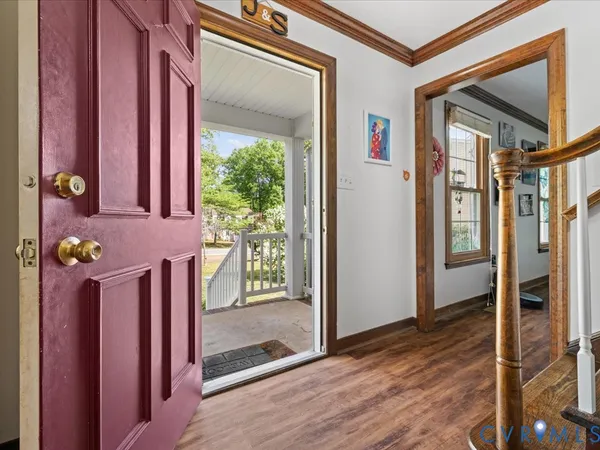a view of entryway and hall with wooden floor