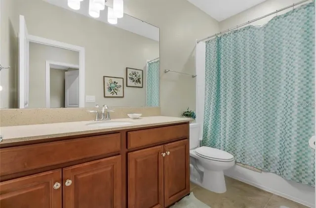 a bathroom with a toilet a sink and a mirror
