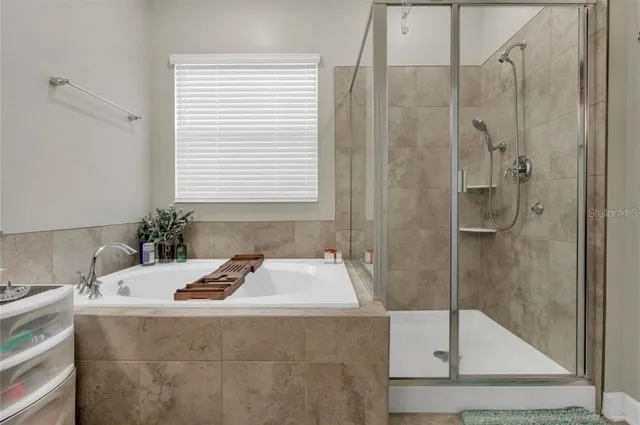 a bathroom with a tub sink and shower