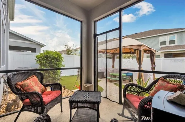 a balcony with table and chairs