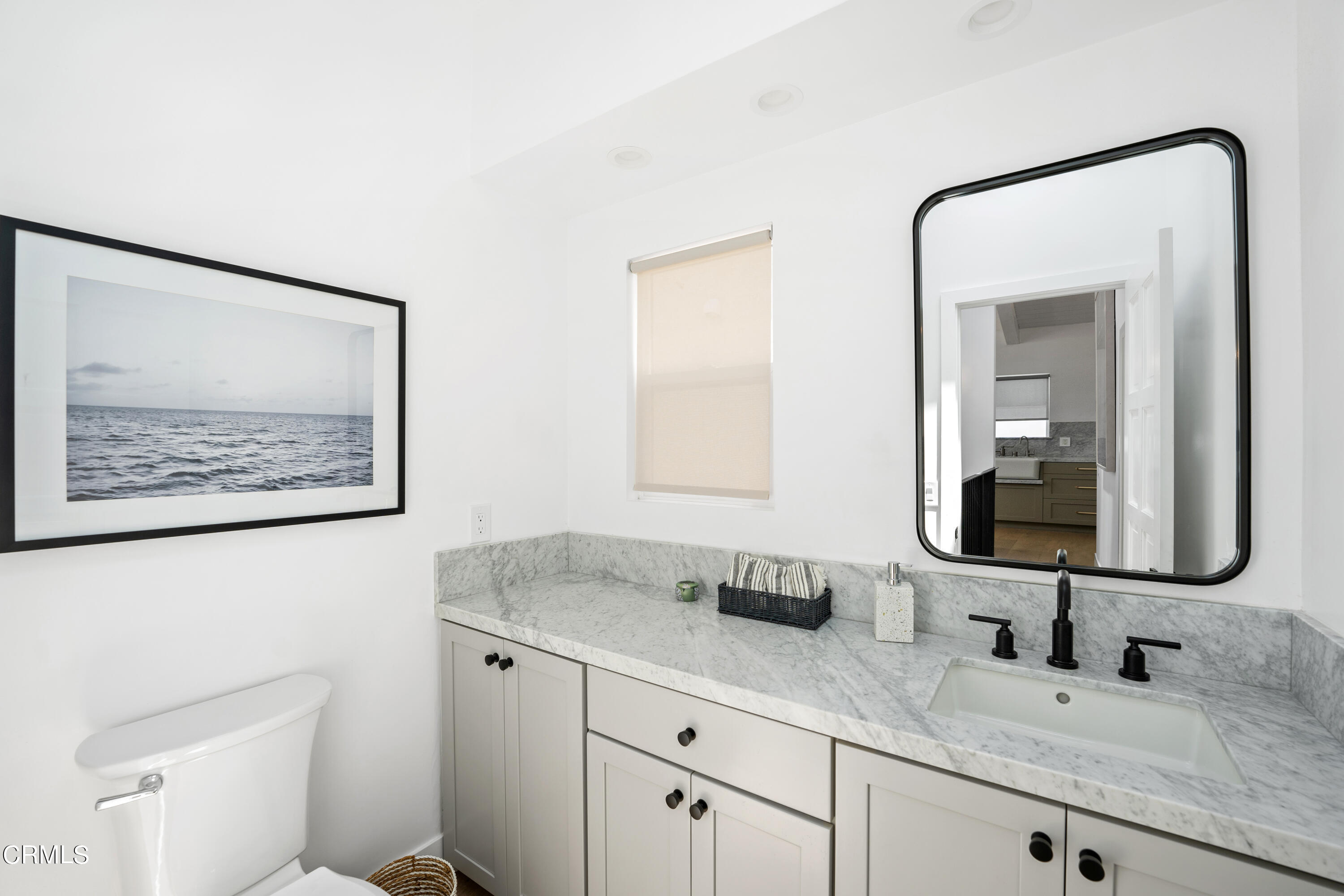4169 Sunset Lane Oxnard, CA 93035 - Photo 45 of 56 a bathroom with a granite countertop sink and a mirror