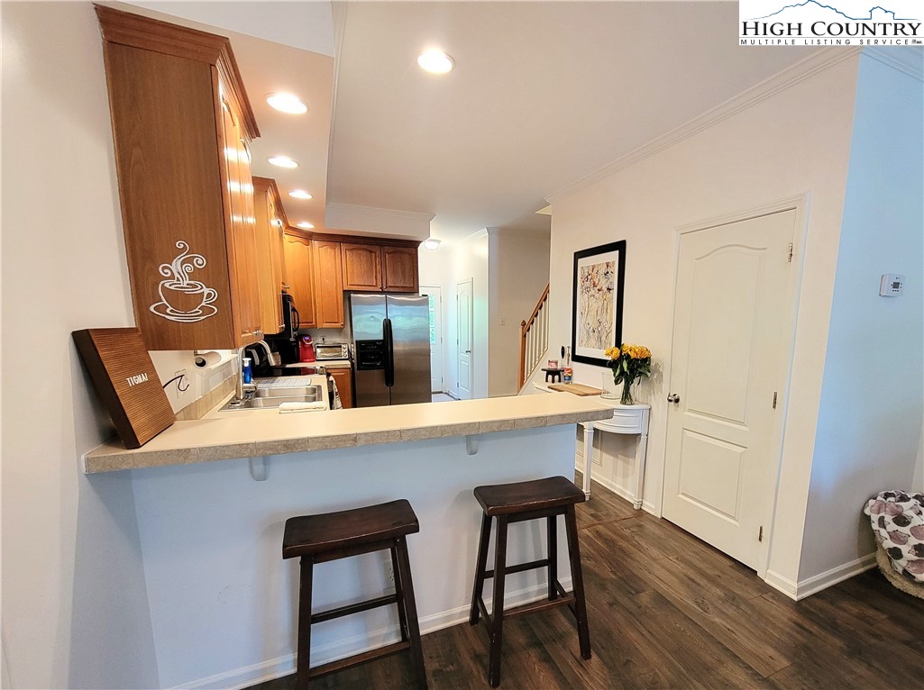 107 Stratford Lane, Unit 24B Boone, NC 28607 - Photo 11 of 45 a kitchen with a sink cabinets and wooden floor