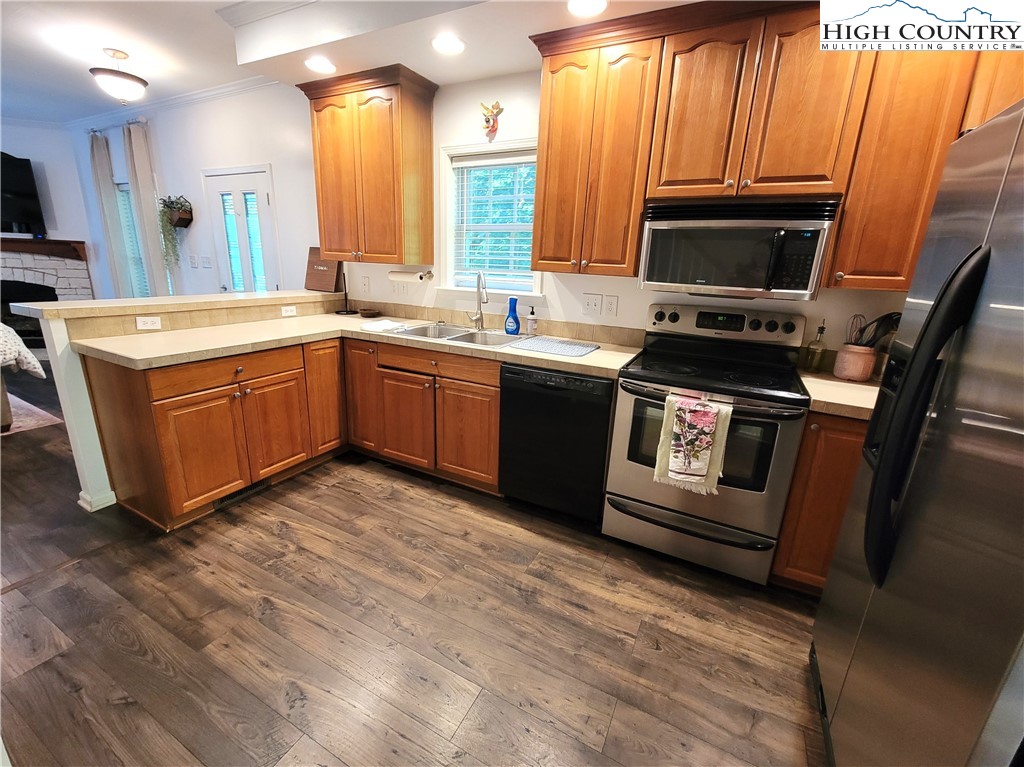 107 Stratford Lane, Unit 24B Boone, NC 28607 - Photo 13 of 45 a kitchen with stainless steel appliances granite countertop a stove a sink and a microwave