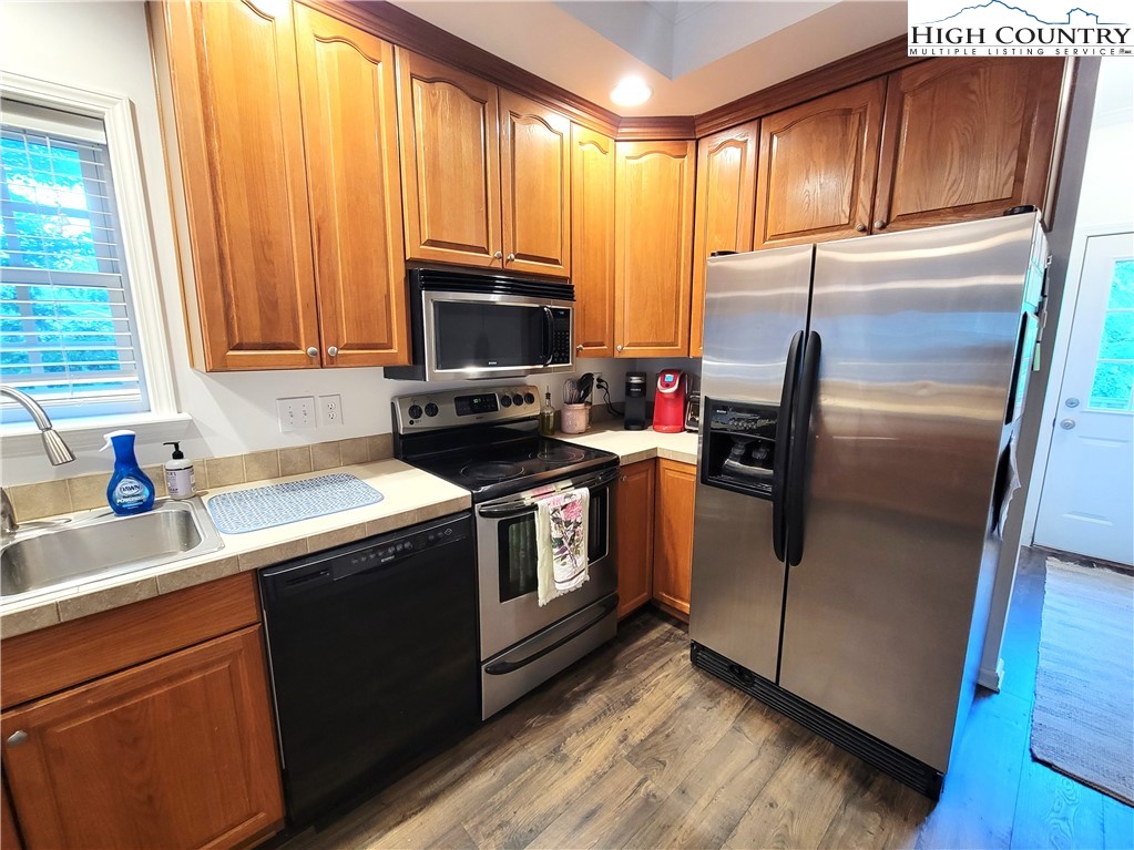 107 Stratford Lane, Unit 24B Boone, NC 28607 - Photo 16 of 45 a kitchen with stainless steel appliances a refrigerator stove and sink