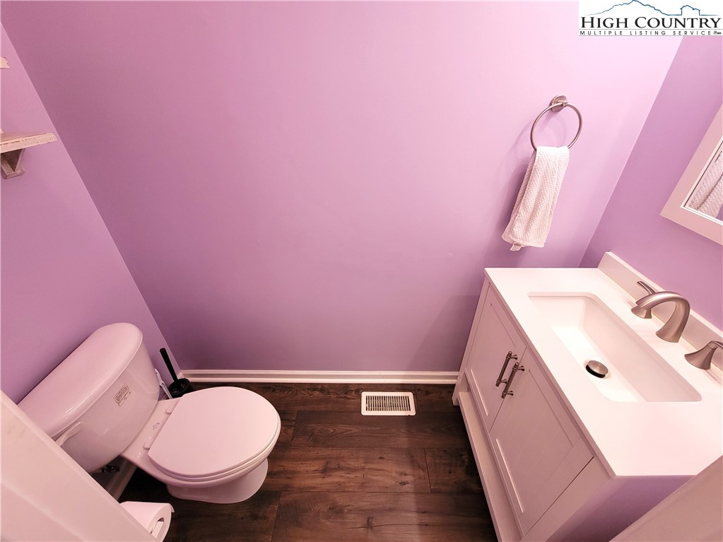 107 Stratford Lane, Unit 24B Boone, NC 28607 - Photo 20 of 45 a bathroom with a sink a toilet a mirror and vanity