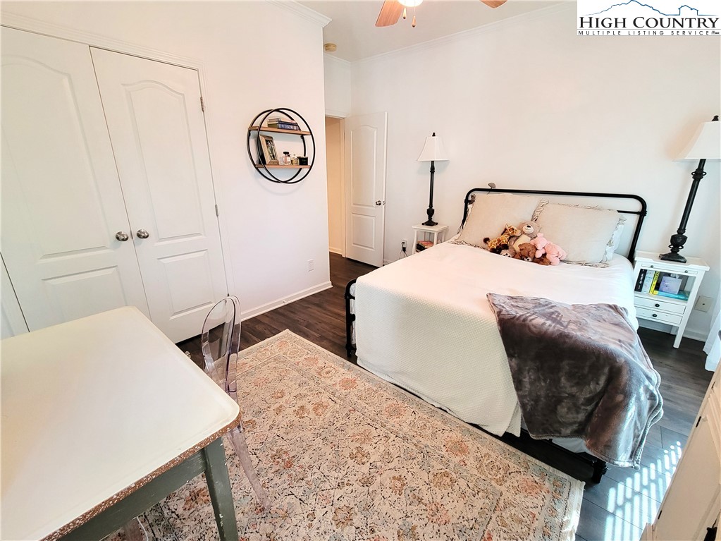 107 Stratford Lane, Unit 24B Boone, NC 28607 - Photo 23 of 45 a bedroom with a bed and wooden floor