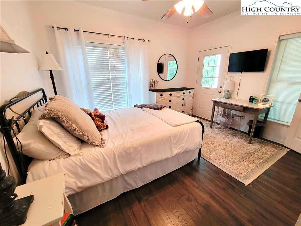107 Stratford Lane, Unit 24B Boone, NC 28607 - Photo 24 of 45 a bedroom with a bed window and a flat screen tv